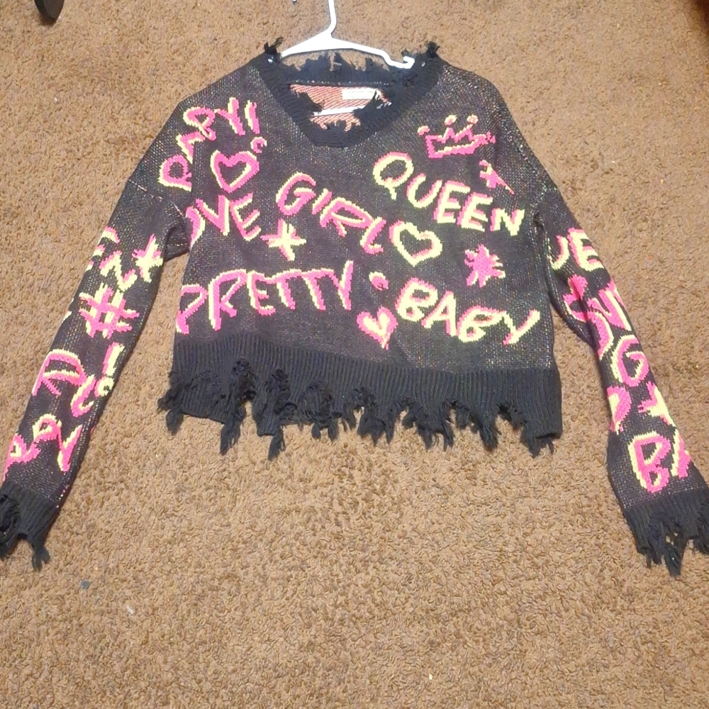 Black sweater with yellow and pink writting says queen baby pretty love